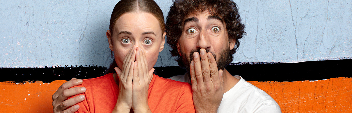 Surprised female and male friends